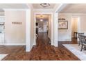 Spacious hallway with hardwood floors, white trim and decorative accents leading to other living areas at 486 Raven Brook Ln, Suwanee, GA 30024