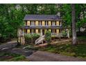 Charming two-story home features a welcoming front porch and a serene, wooded setting at 2253 Creekstone Ct, Marietta, GA 30062