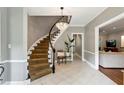 Grand foyer featuring a curved staircase with a chandelier and tile flooring at 230 Seamarsh Ct, Atlanta, GA 30328