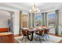 Bright dining room with wainscoting, big windows, and views into the living area at 5115 Edgebrook Dr, Cumming, GA 30040