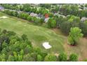 Stunning aerial view of the property on the golf course surrounded by lush greenery at 5309 Davenport Mnr, Cumming, GA 30041