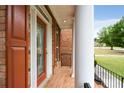 Inviting front porch with brick flooring and white columns showcasing a cozy entrance at 650 Virginia Highlands, Fayetteville, GA 30215
