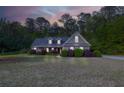 Inviting single-Gathering home at twilight with well-maintained landscaping and a serene, peaceful setting at 152 Cooper Creek Dr, Dallas, GA 30157
