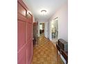 Inviting entryway with hardwood floors, light pink walls, and a view into other rooms at 387 Cascade Sw Dr, Lilburn, GA 30047
