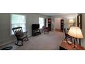 This well-lit living room boasts large windows, a rocking chair, and plenty of space to relax or entertain at 387 Cascade Sw Dr, Lilburn, GA 30047