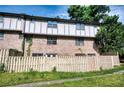 Back of townhome with a wooden fence and lush green lawn at 1151 Rankin St # 2C, Stone Mountain, GA 30083