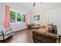 Bright living room with hardwood floors, neutral walls, large windows, and comfortable leather sofas at 2909 Jones Mill Rd, Atlanta, GA 30360