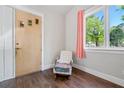 Cozy sitting room featuring hardwood floors, large windows with views, and a classic rocking chair at 2909 Jones Mill Rd, Atlanta, GA 30360