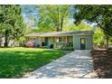 Inviting exterior view showcasing the lush front lawn, freshly painted home, and charming curb appeal at 3099 Dove Way, Decatur, GA 30033