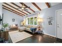 Cozy living room boasts exposed beams, natural light, and stylish furnishings, creating an inviting atmosphere at 3099 Dove Way, Decatur, GA 30033