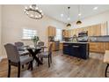 Modern kitchen and dining area with stainless steel appliances, island, and pendant lighting at 501 Dargan Sw Pl, Atlanta, GA 30310