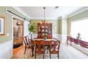 Elegant dining room featuring a chandelier, wainscoting, and ample natural light at 905 Downyshire Dr, Lawrenceville, GA 30044