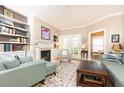 Comfortable living room featuring a fireplace, built-in shelving, and french doors at 211 Colonial Homes Nw Dr # 2508, Atlanta, GA 30309