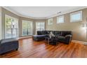 Comfortable living room featuring hardwood floors, crown molding, and large windows at 4240 Hastings Dr, Cumming, GA 30041