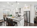 Modern kitchen featuring a central island, stainless steel appliances, and ample counter space at 3786 Alstead Manor Way, Suwanee, GA 30024