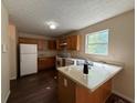 Functional kitchen design with oak cabinets, laminate countertops, and modern appliances at 5280 Tussahaw Xing, Mcdonough, GA 30252