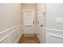 Entryway featuring hardwood floors, white trim, and a door leading to the exterior with built-in blinds at 1024 Burke St # 56, Lawrenceville, GA 30046