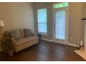 Bright living room with stylish sofa, hardwood floors, and access to natural lighting at 2253 Dillard Xing, Tucker, GA 30084