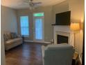 Cozy living room with fireplace, offering hardwood floors, plush seating, and natural light at 2253 Dillard Xing, Tucker, GA 30084