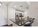 Eat-in kitchen featuring granite countertops, stainless steel appliances, and bar-stool seating at 3040 Peachtree Nw Rd # 713, Atlanta, GA 30305