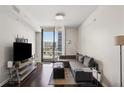 Inviting living room with floor-to-ceiling windows and comfortable seating, great views of the city at 3040 Peachtree Nw Rd # 713, Atlanta, GA 30305