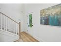 Bright entryway with hardwood floors, white staircase, and a modern front door with glass panels at 1347 Midlawn Dr, Decatur, GA 30032