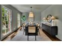 Modern dining room features a large table, designer lighting, and a sleek sideboard at 1430 Dallas Circle Sw, Marietta, GA 30064