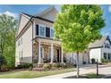 Inviting two-story home with a stone facade, porch, and three-car garage at 10140 Grandview Sq, Duluth, GA 30097