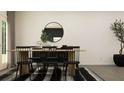 Modern dining area featuring a wood table, stylish seating, and decorative elements at 2425 Livi Ln, Buford, GA 30519