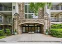 Attractive stone building entrance with arched doorway and black framed windows at 3047 Lenox Ne Rd # 2105, Atlanta, GA 30324