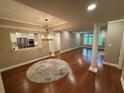 Open-concept living room with hardwood floors and natural light flowing in through the windows at 3047 Lenox Ne Rd # 2105, Atlanta, GA 30324