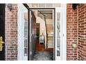 Open foyer with hardwood floors, staircase, and elegant decor is visible through the beveled glass front door at 8640 Amsbury Way, Cumming, GA 30041