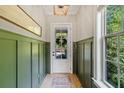 Elegant foyer featuring wainscoting, a decorative rug, and a window offering natural light, creating a welcoming entrance at 2166 Sonoma Se Dr, Smyrna, GA 30080