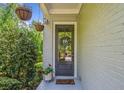 Inviting entryway with a decorative wreath, potted plants, and hanging flower baskets, creating a warm and welcoming ambiance at 2166 Sonoma Se Dr, Smyrna, GA 30080