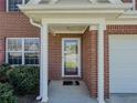 Close-up of the home's entrance, featuring a brick facade and covered porch at 2775 Storybook Ct, Grayson, GA 30017