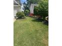 Spacious backyard with lush lawn and landscaped flower beds at 280 Ridge Bluff Ln, Suwanee, GA 30024