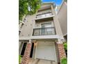 Townhome exterior featuring a front-entry garage, brick columns and private balconies at 4254 River Green Nw Dr # 612, Atlanta, GA 30327