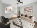 Bright living room features modern decor, a ceiling fan and an open floorplan leading to the kitchen at 4254 River Green Nw Dr # 612, Atlanta, GA 30327