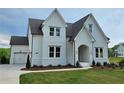 Charming home featuring white siding, attached garage, and a well-maintained lawn at 6490 Mockingbird Rd, Cumming, GA 30028