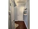 Well-lit hallway features hardwood floors, floating shelving, and white paneled doors, creating a cozy entrance at 1280 W Peachtree Nw St # 2801, Atlanta, GA 30309