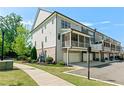 View of the townhome's back exterior, featuring a patio and garage access at 130 Inwood Walk, Woodstock, GA 30188