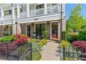 Close-up of the townhome's entrance with landscaped garden and an inviting porch at 130 Inwood Walk, Woodstock, GA 30188