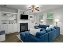Cozy living room featuring a fireplace, built-in shelving, and comfortable blue seating at 4422 Richmond Se Ct, Stone Mountain, GA 30083