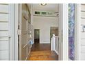 View of the entryway with hardwood floors and decorative glass on the front door at 1131 Bailing Dr, Lawrenceville, GA 30043
