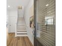 Inviting entryway with wood floors, staircase, and an art piece at 2815 Habibi Ct, Buford, GA 30519
