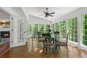 Bright sunroom with large windows, hardwood floors, and a dining set at 1440 Sandford Sw Trl, Lilburn, GA 30047