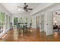 Bright sunroom with large windows, hardwood floors, and a dining set at 1440 Sandford Sw Trl, Lilburn, GA 30047