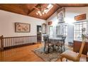 A dining room with hardwood floors, a wood ceiling, and a skylight at 2004 Poplar Falls Rd, Lithonia, GA 30058