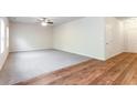 Open-concept living room featuring plush carpet, hardwood flooring, and ample natural light at 2352 Allman Dr, Jonesboro, GA 30236