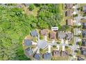 Aerial view of a home in a residential area surrounded by lush greenery and other well-maintained properties at 3178 Arbor Oaks Way, Snellville, GA 30039